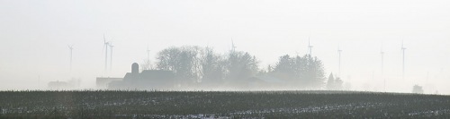 A windfarm in the fog.